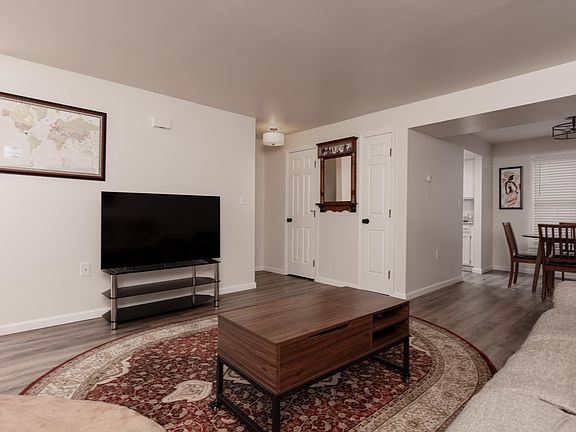 Door to left of mirror is 1/2 bathroom; door to right of mirror is storage closet