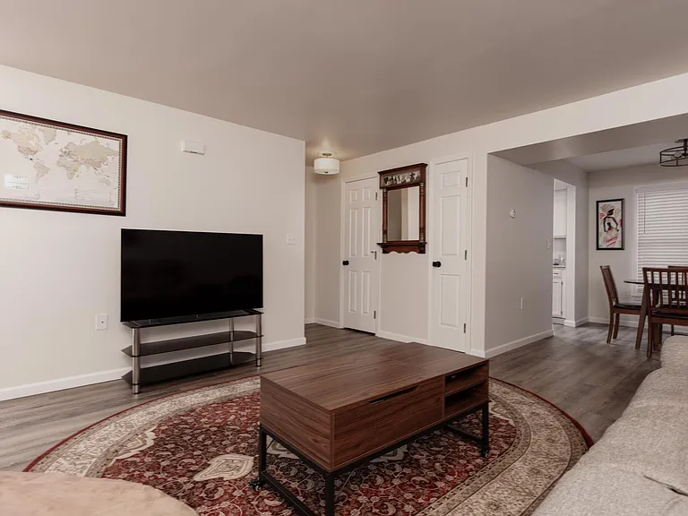 Door to left of mirror is 1/2 bathroom; door to right of mirror is storage closet
