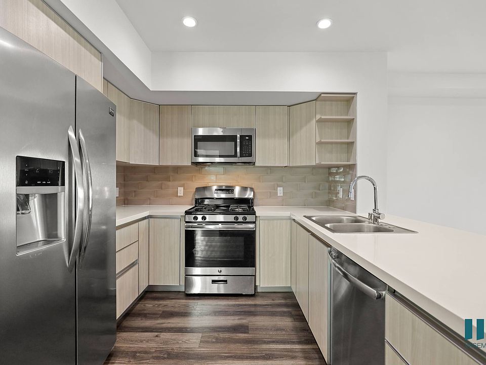 Large-Size Kitchen with Stainless-Steel Refrigerator, Stove, Microwave Oven, and Dishwasher