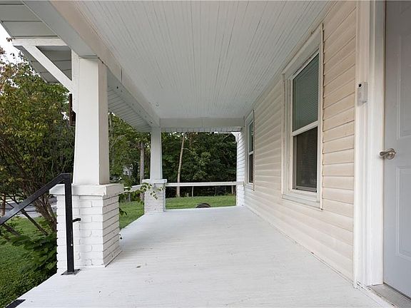 Covered porch with white painted flooring and ceiling
