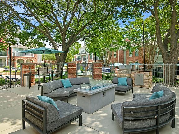 Outdoor entertainment space that's outfitted with a grilling station and abundant seating.