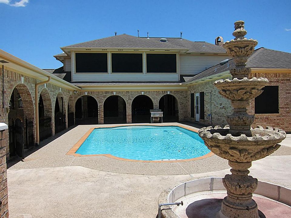 GORGEOUS IN GROUND POOL IN STATUESQUE BACK YARD