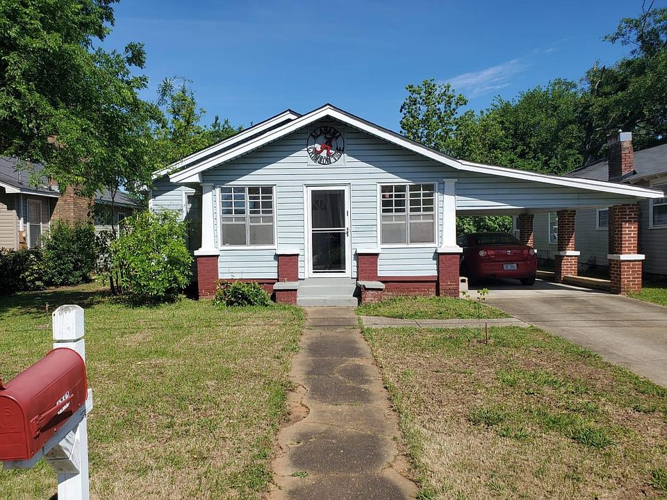 Front of home with carport. Front and side sunroom door.