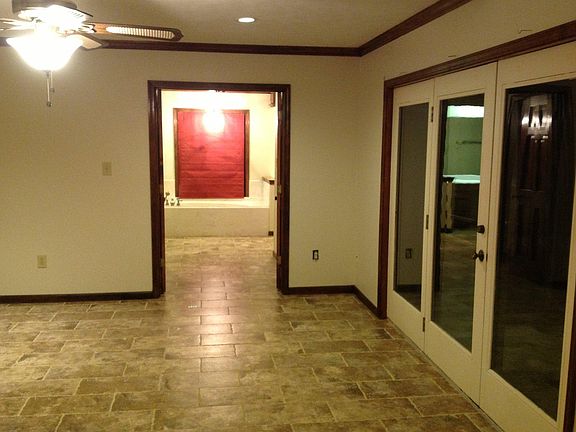 View of Master Bedroom from entry doorway; great view across deck of rising sun through the trees; his//hers vanities; his/hers walk in closets, enclosed toilet, enclosed shower, very SPACIOUS.