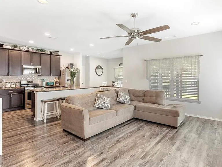 THE GENEROUSLY SIZED LIVING AREA, ADJACENT TO THE LIGHT, BRIGHT KITCHEN!