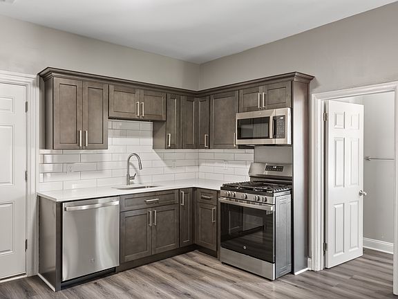 Kitchen with gas stove and dishwasher. All new appliances, quartz counters and new cabinets.