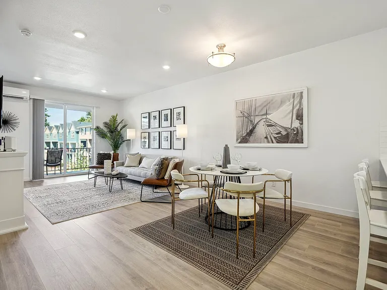 Large open floorplan layout accommodates barstool, a full dining set and living room furniture.
