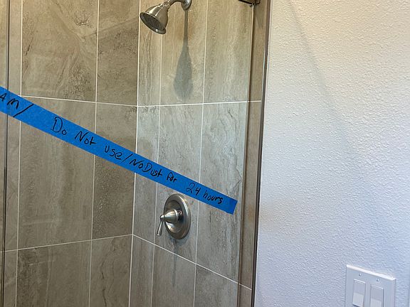 upscale floor to ceiling shower with Bench