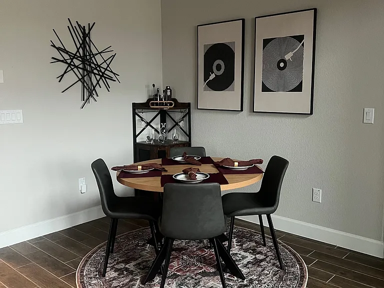 Stylish dining area featuring modern decor, a cozy round table, and elegant finishes_perfect for intimate meals or entertaining guests in a warm, inviting space.