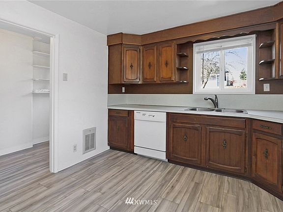 Kitchen with appliances and new vinyl plank tile flooring