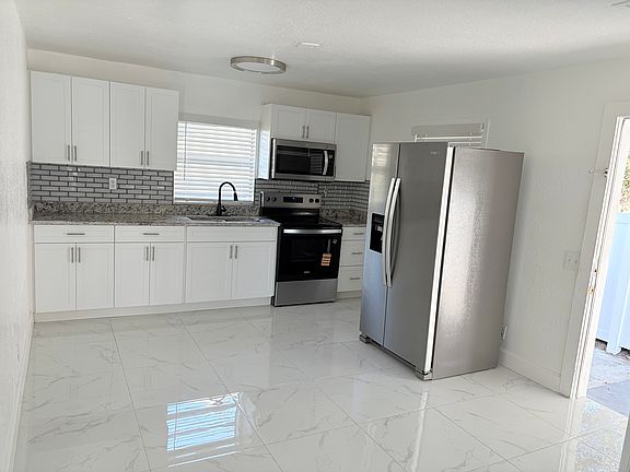 view of the kitchen area and a portion of the side door that goes to the carport