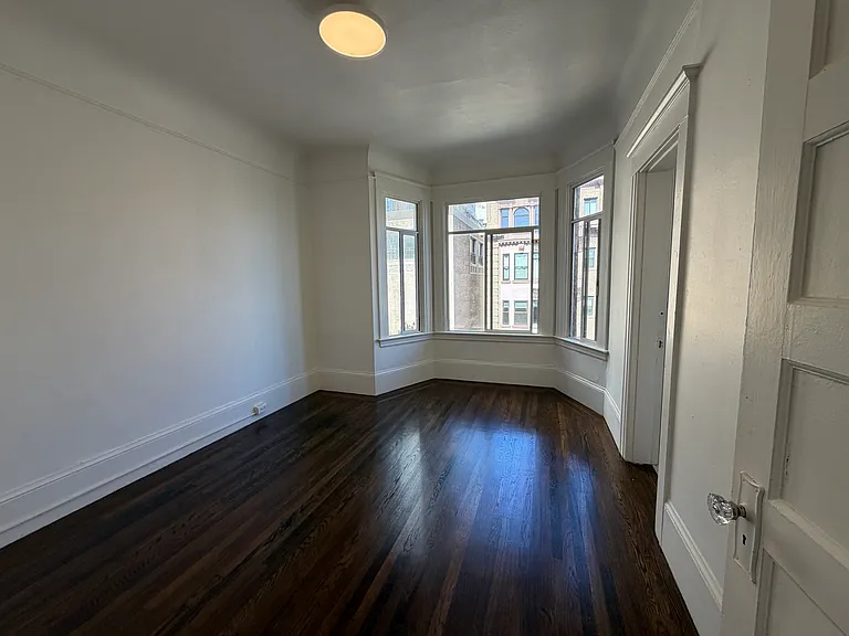 Bedroom 2 separated by walls and bathroom. Bay windows here as well.