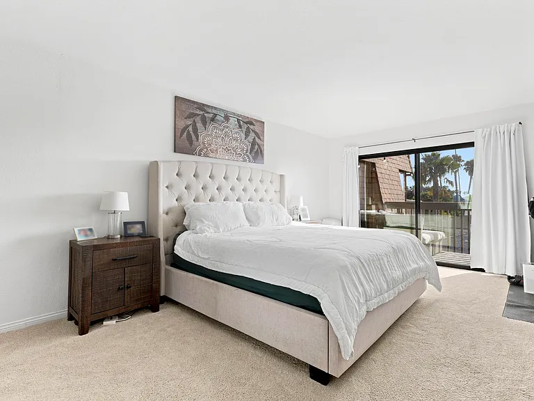Large primary bedroom with slider out to balcony
