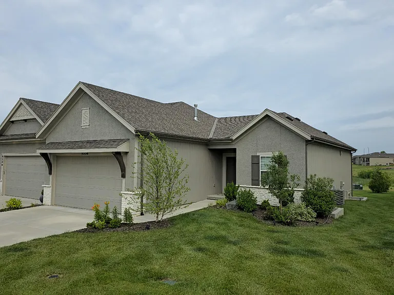 Front features premium landscaping, just steps from a beautiful lake and walking trails.