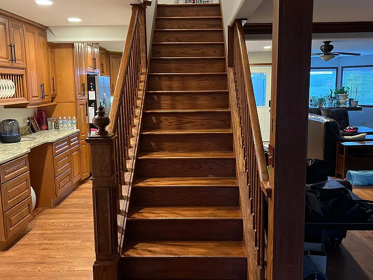Stairs going up to 2nd floor. Left side goes through the Butler's breezeway/pantry to the kitchen. While the right side goes through the formal dining area into the kitchen, living room, tv viewing area, and casual dining areas.
