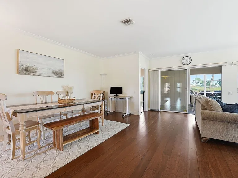Dining area is open to living room and office space featuring a standing desk