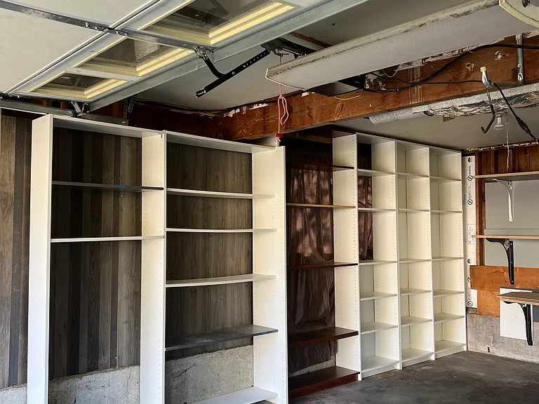 Garage has lots of storage with 220v outlet for EV charging