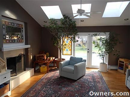 Gorgeous den with fireplace & vaulted ceilings with skylights!