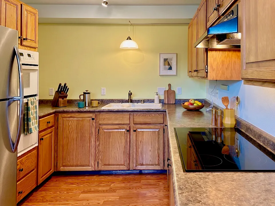 Spacious kitchen with lots of counter space and cabinets, microwave and convection oven, cooktop, stainless fridge and dishwasher.