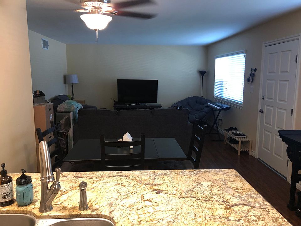 Kitchen looking to large living room and front door entry.