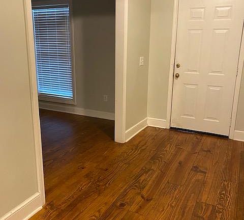 Foyer view at front door and dining room on the left