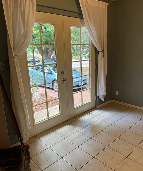 Beautiful french doors to a small front porch. Nice to sit outside with a morning coffee or evening happy hour.