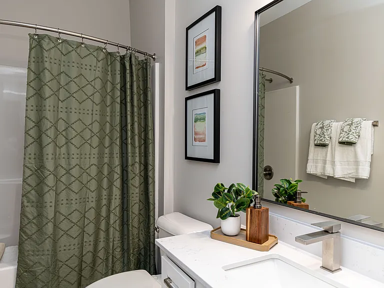 Bright bathroom with quartz counters and high-rise faucets