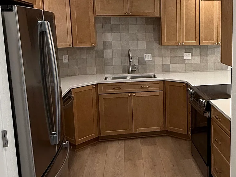 Completely renovated kitchen with custom maple cabinets (soft-close doors and drawers!) with storage savvy design, tiled backsplash and all new GE large appliances.