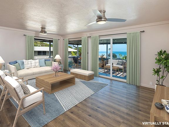 Upstairs Living Room with Balcony access and sweeping ocean views. All photos with furniture are virtually staged. Home will be rented vacant with no furniture.
