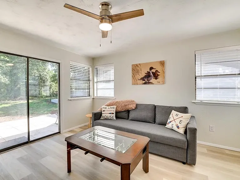 Sunroom, 2 sitting chairs, fold out futon, foosball table, and sliding door to backyard patio.