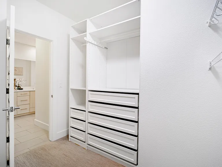 Walk in closet next to master bathroom