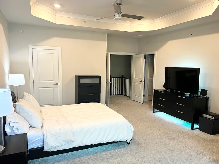 Large Owner's Bedroom features tray ceiling, TWO walk-in closets (one is a huge 12.5' x 6.5'), en suite bathroom, and smart ceiling fan