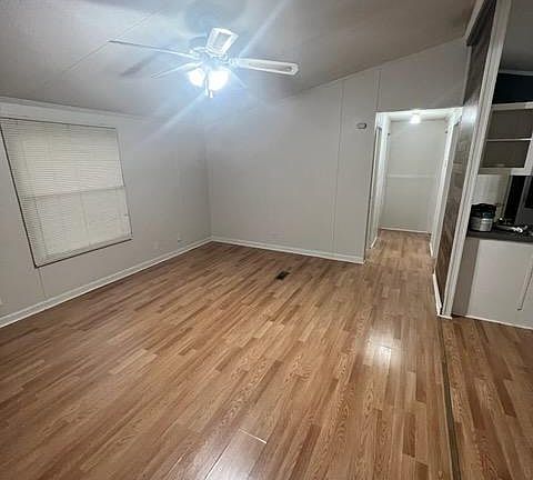 View from the master bedroom looking at the living room and down the hall to the other two bedrooms and bath.