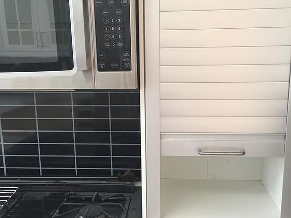 Gas stove with overhead microwave
