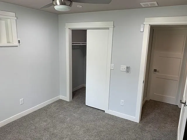 Lower level large bedroom showing closet and ceiling fan