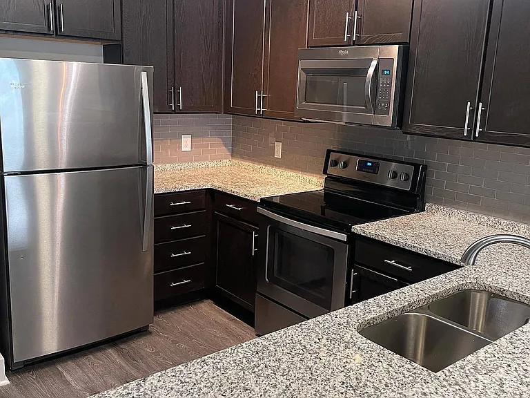 Chef's Kitchen with Modern Appliances, Countertops, & Lighting