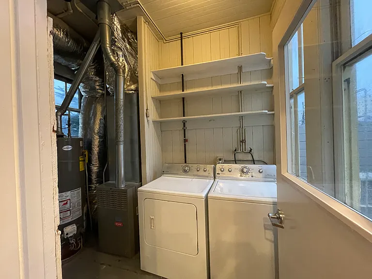 Private Washer & Dryer with Storage Shelves Directly Off of Kitchen