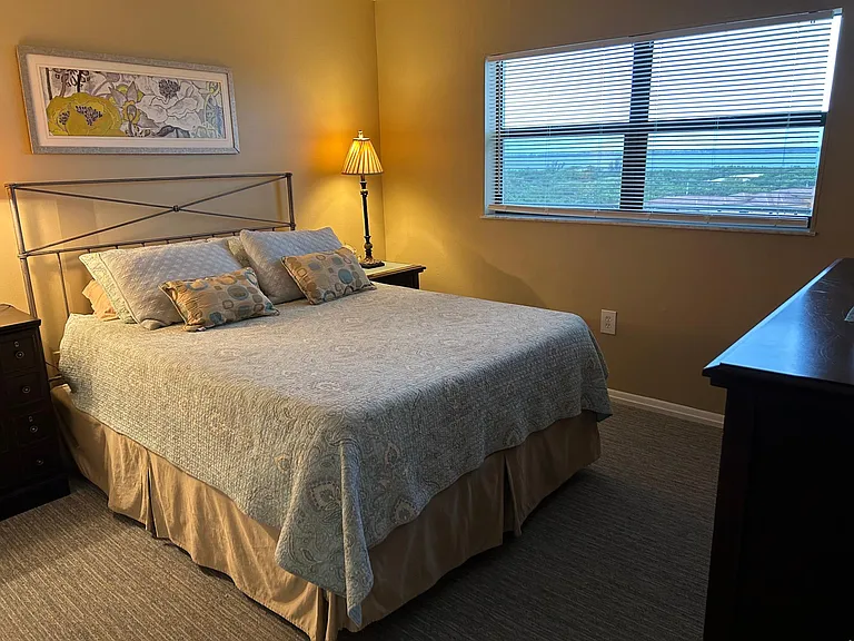 Spare bedroom with queen bed, smart TV and view of the Indian River.
