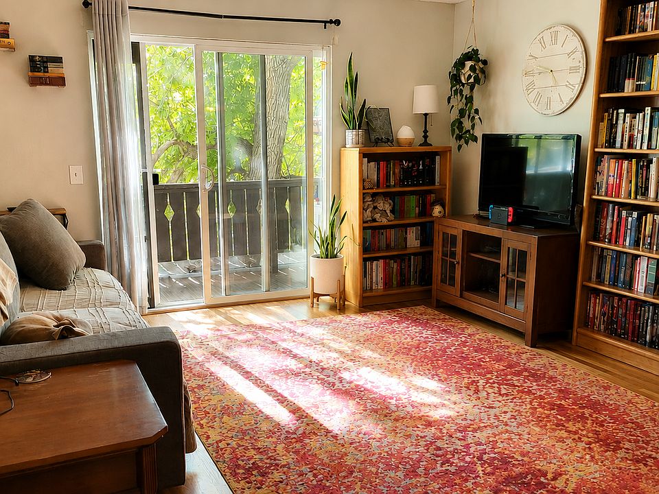 Living room with a west facing sliding glass door. Private balcony.