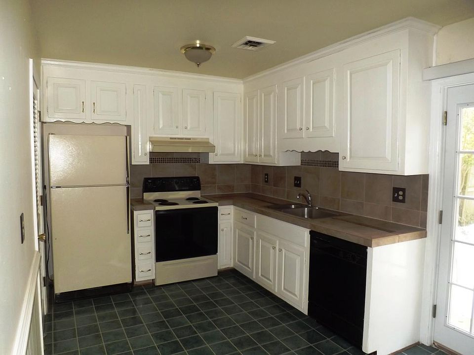 Kitchen has ceramic tile counter tops and backsplash; electr