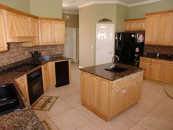 Chef's kitchen, granite, center island, wine cooler and lots of cabinets.