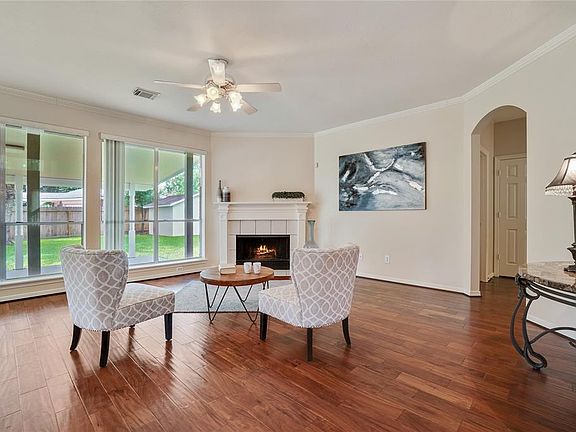 Floor-to-ceiling windows span the back side of the home overlooking the spacious patio and backyard.