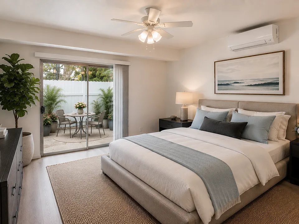 Apartment 1A Master Bedroom with sliding doors to patio. Furnished for illustrative purposes.