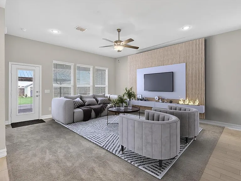 Living area featuring a modern accent wall with a built-in linear fireplace, recessed lighting, and a ceiling fan