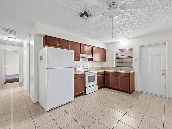 Kitchen with fridge, stove, oven and range hood