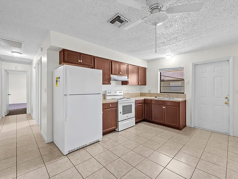 Kitchen with fridge, stove, oven and range hood
