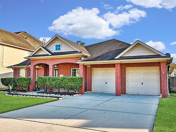 Roof line extends over driveway providing extra coverage. Owners have installed an exterior outlet under garage soffit for holiday lighting.