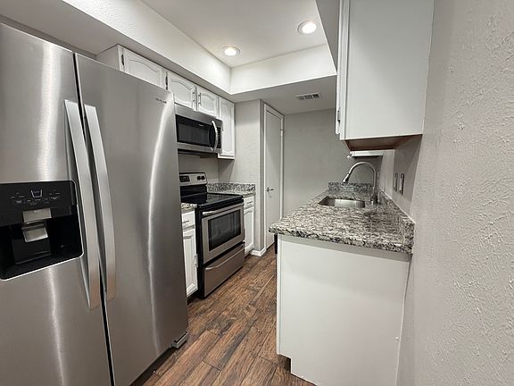 Kitchen with granite countertops and stainless steel.
