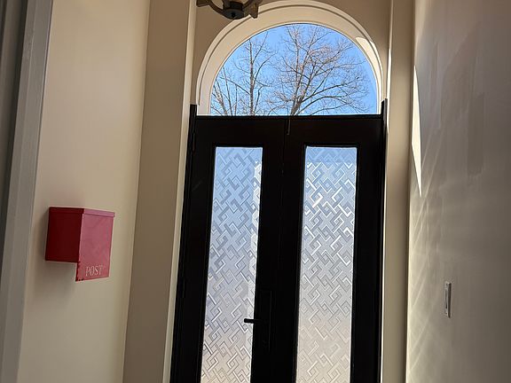 Beautiful foyer with farmhouse chandelier.
