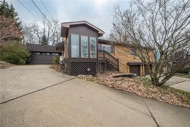 Front view of home.  Attached garage on left of home and 2 integral garages on lower level.